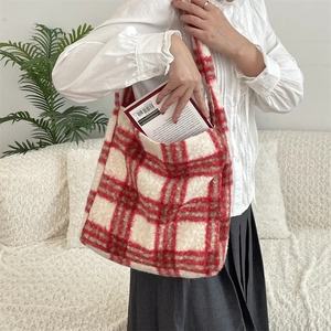 Detail view of large red and white plaid plush tote bag showing soft faux fur texture