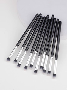 Detail of 12-piece eye makeup brush set with black handles and silver ferrules