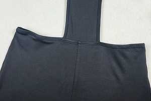 Close-up of reinforced double-stitched seams on black matte stretch fabric bodysuit