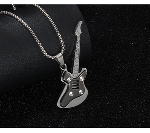 Close-up of guitar pendant with clear rhinestones on silver-tone box chain necklace