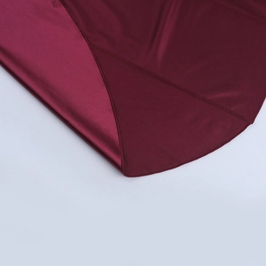 Macro detail of the wine red satin fabric showing smooth texture and fine stitching work