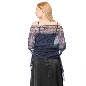 Detail of navy blue floral lace shawl with delicate tassels on a black evening dress