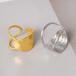 Detail of 18k gold and silver adjustable rings with irregular hammered metal texture