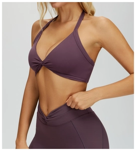 Detail of deep purple halter yoga bra featuring a stylish center knot design for fitness