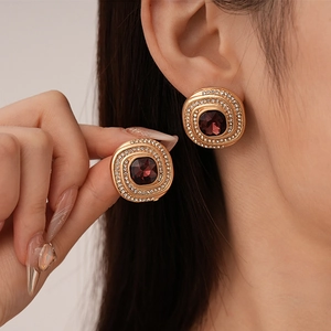 Vintage gold swirls earrings with sparkling diamonds and a square burgundy gemstone center