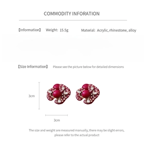 Macro view of vintage style deep red flower earrings with rhinestones and 3cm size spec
