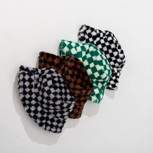 Plush checkerboard bucket hats in black, grey, brown, and green for winter warmth