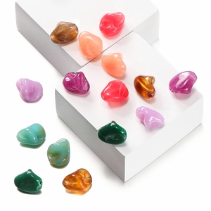 Macro shot of colorful irregular acrylic beads with marble texture for DIY jewelry making