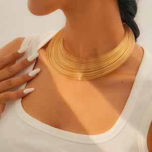 Nahaufnahme eines minimalistischen mehrlagigen Gold-Chokers am Hals eines Models