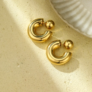 Minimalist gold-plated hollow C-shape stud earrings with spherical ends on stone base