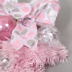 Pink Christmas teardrop wreath with bows and ornaments for festive door decoration