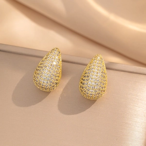 Sparkling gold teardrop stud earrings with micro-pave crystals on elegant satin base