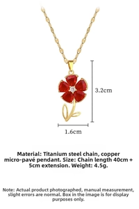 Macro detail of gold flower pendant featuring red crystals and a center sparkling diamond