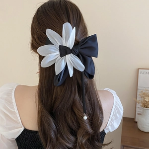Elegant large black satin bow hair clip with white daisy petal and pearl drop accessory