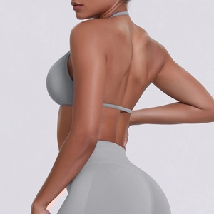 Detail view of seamless grey halter sports bra and high-waist leggings on a model