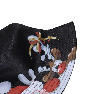 Detailed view of Santa and reindeer prints on a black satin Christmas bucket hat