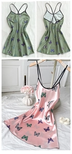 Detail of silk-like camisole nightdress with butterfly print and thin cross straps