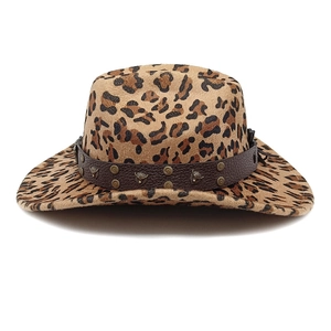 Detail of leopard print cowboy hat with leather band and metal wolf head ornament