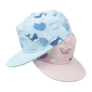 Detail of kids snapback hats featuring whale and rainbow prints on soft twill cotton fabric