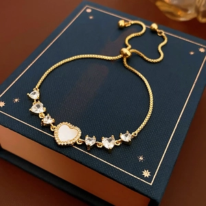 Detail showing gold plated heart bracelet with zircon stones and adjustable drawstring chain
