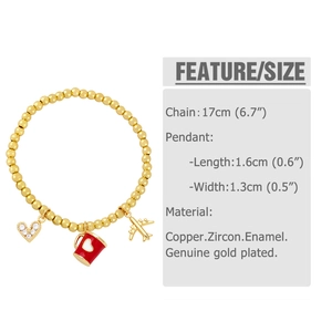 Detail of gold beaded bracelet with airplane, enamel cup, and zircon heart charms