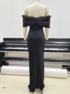 Detail of elegant black off-shoulder evening gown with a large decorative back bow