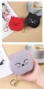 Detailed view of mini cat coin pouches in red, black and purple with metal keychains