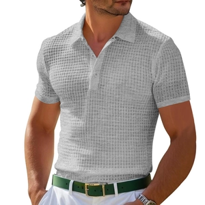 Detailed close-up of men's grey waffle knit polo shirt showing fabric texture and buttons