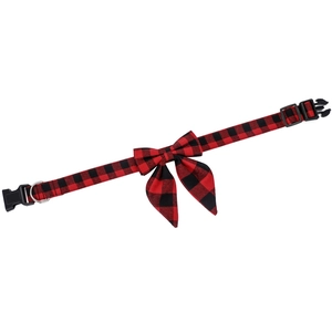 Close-up of red and black plaid dog collar with bow tie, buckle, and metal D-ring detail