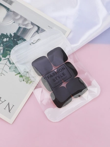 Set of six black matte square finger puffs in a clear zip bag on aesthetic background