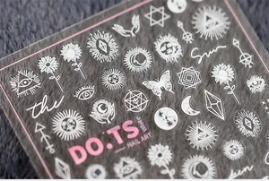 Detailed view of 5D white nail art stickers with mystic eye, sun and moon symbols