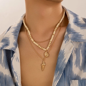 Men's layered necklace featuring beige beads, gold chains, and a stylish shell pendant