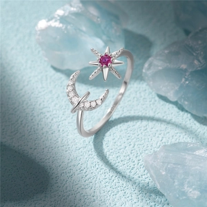 Macro shot of S925 silver ring featuring moon pavé and star with pink center stone