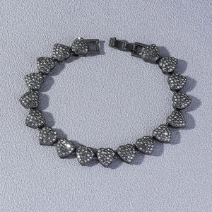 Detail of hip-hop heart link bracelet with black micro-pave stones and fold-over clasp