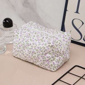 Detailed macro view of floral quilted toiletry bag with high-quality zipper closure