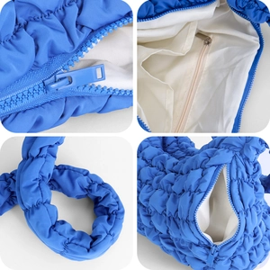 Blue pleated cloud shoulder bag with quilted texture and spacious interior detail