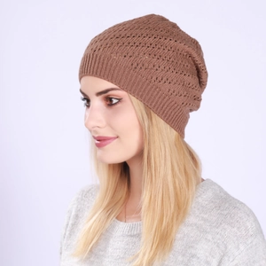 Detailed texture of brown openwork knit beanie with ribbed edge on a fashion model