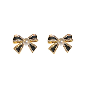 Vintage gold bow earrings with black enamel, pearls and sparkling zircons for women