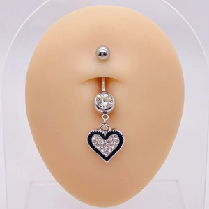 Macro view of stainless steel belly ring with black heart pendant on body model