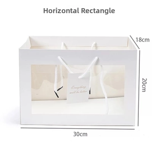 Detailed view of horizontal white gift bag with large clear window and 30x18x20cm dimensions