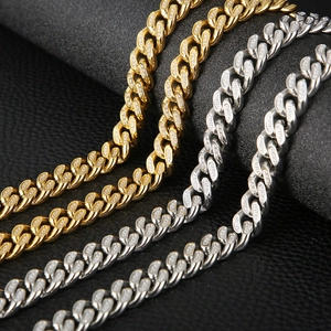 Macro detail of gold and silver cuban link chains with pave-set zircon on black leather
