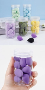 Macro shot of colorful teardrop sponges in a transparent jar for smooth makeup application