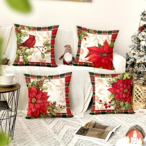 Close-up of four Christmas pillow covers with red birds, poinsettias and plaid borders