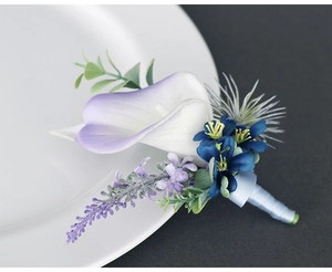 Detail of handmade purple calla lily boutonniere with lavender and blue ribbon wrap
