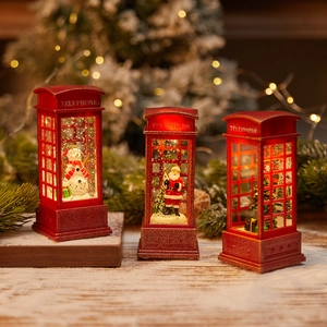 Red Christmas lantern phone booth with Santa and Snowman scenes on fake snow