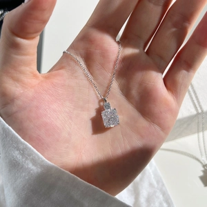 Detailed close-up of a S925 sterling silver perfume bottle pendant with step-cut crystal