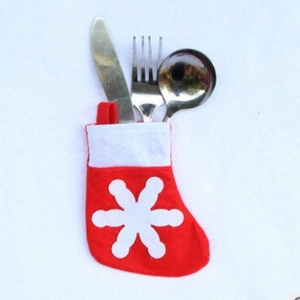 Red Christmas stocking cutlery holder with snowflake pattern on white background