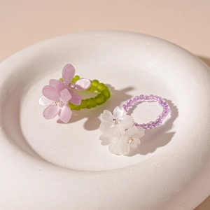 Sweet resin flower beaded ring set with green and purple beads on stone tray