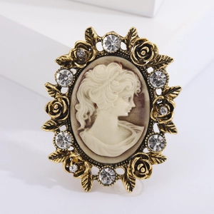 Vintage relief brooch with female silhouette cameo and rose gold rhinestone frame