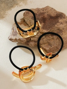 Three-piece set of minimalist gold metal hair ties with abstract geometric designs